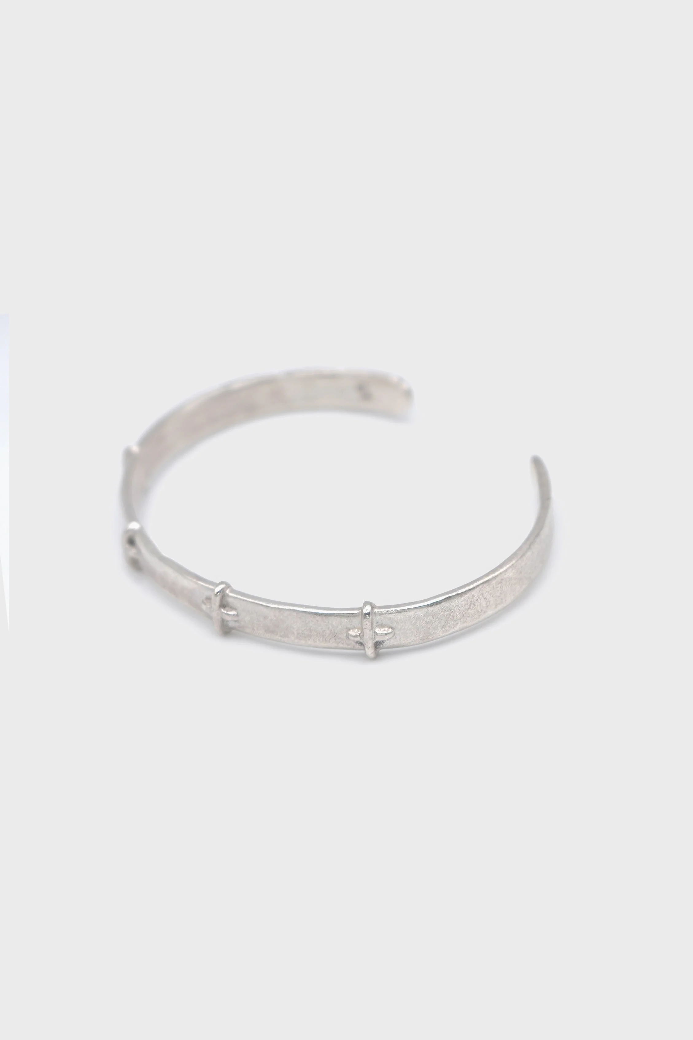 THIN SILVER STITCHED CROSS SILVER BANGLE - Image 2